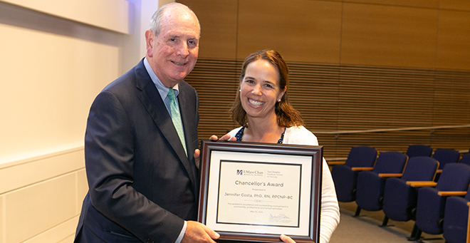 Chancellor Michael F. Collins standing next to Jennifer Costa