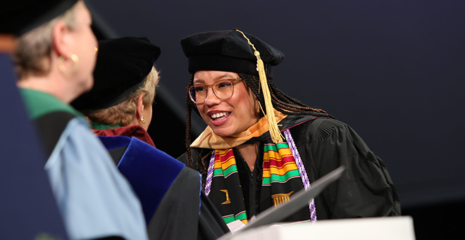 Student receiving degree on stage