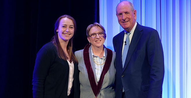 Julia Scanlon and Chancellor Michael F. Collins presenting a medallion to Diane McKee