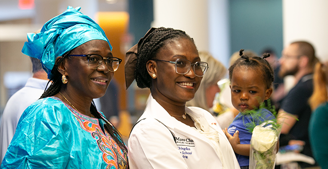 DNP student Makieu Rhida and her family celebratating after the White Coat Ceremony