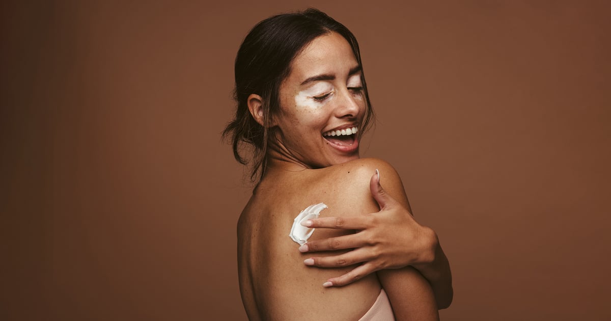 woman applying topical ointment on her back